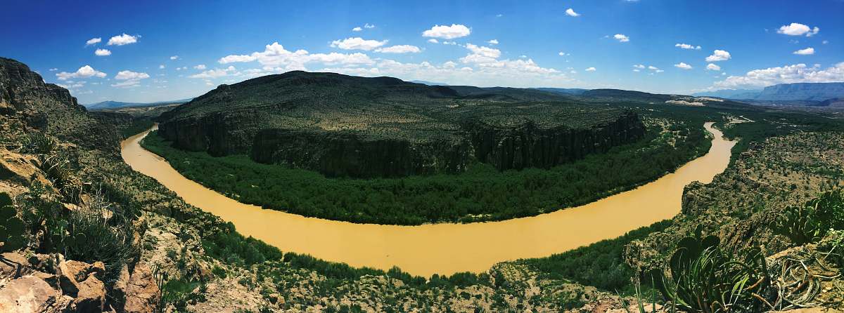 outdoors aerial photography of river beside green mountain during daytime big bend national park