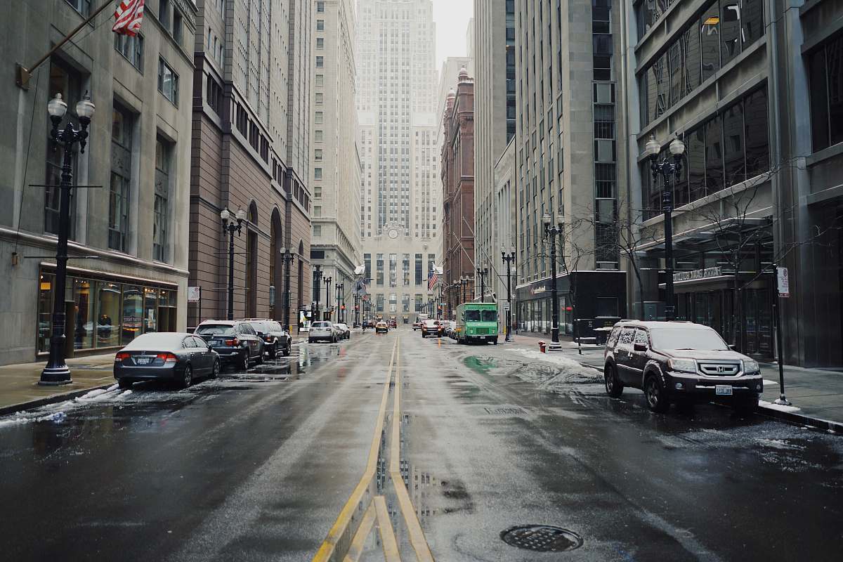 grey parked vehicles beside road and building at daytime street