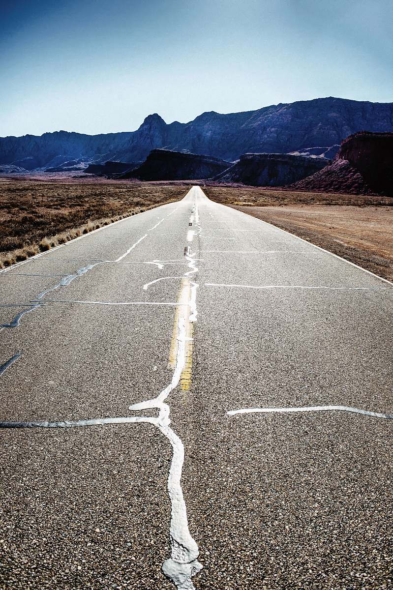 asphalt road towards rocks tarmac