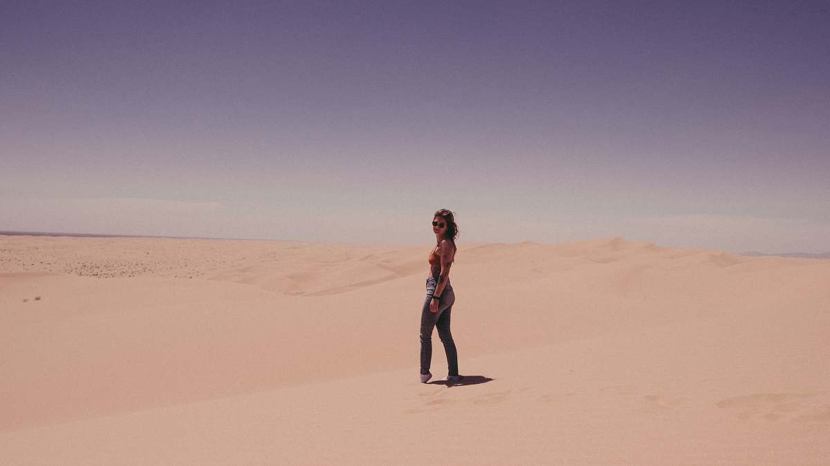 desert woman standing on sand during daytime algodones dunes