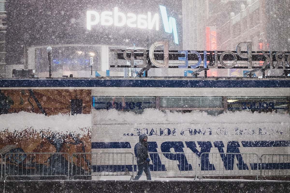 storm closeup photo of a person walking beside rail times square