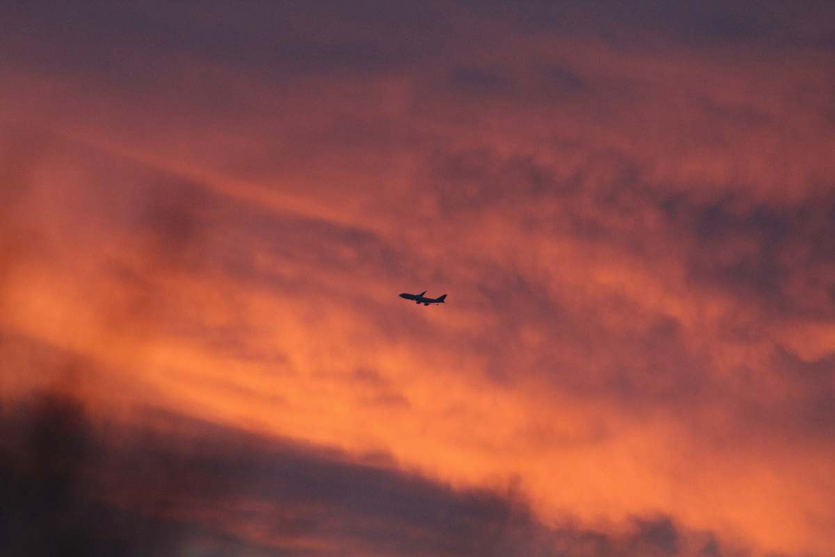 phoenix airliner in sky over golden hour united states
