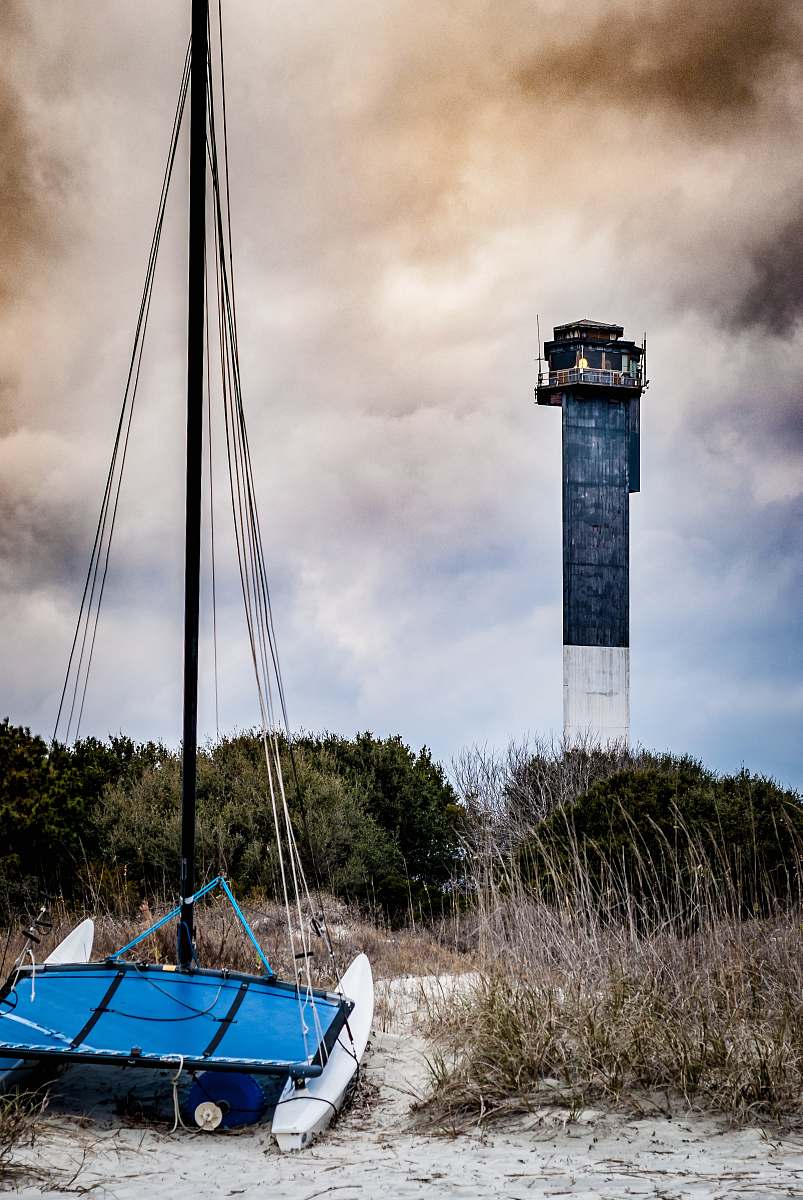boat blue boat near lighthouse vehicle