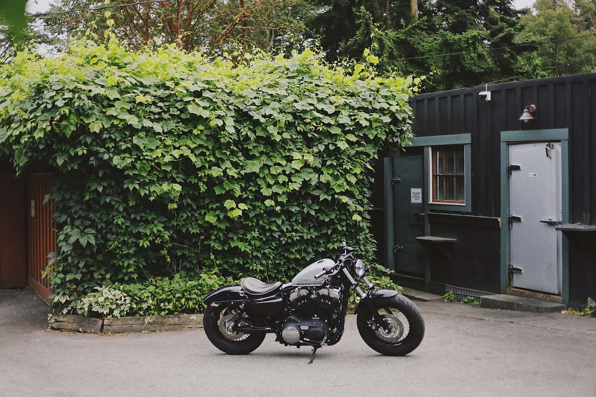 motorcycle gray and black bobber bike parked outdoor during daytime vehicle