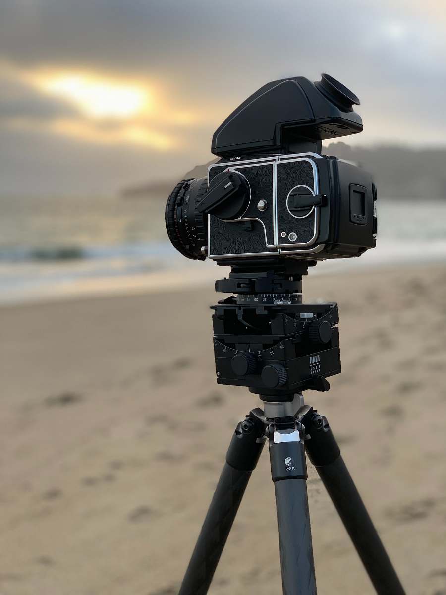 robot selective focus photography of black DSLR camera with tripod sand ladder