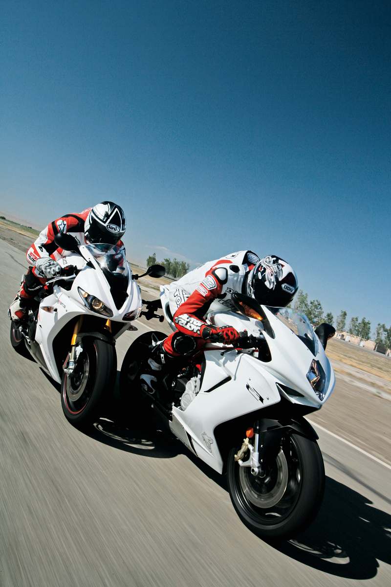 motorcycle two people riding sports bikes on gray asphalt road during daytime transportation