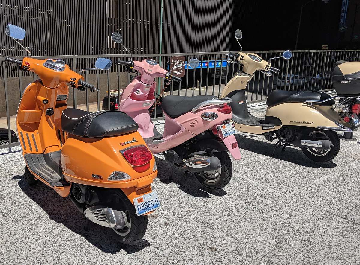 machine three assorted-color motor scooters wheel