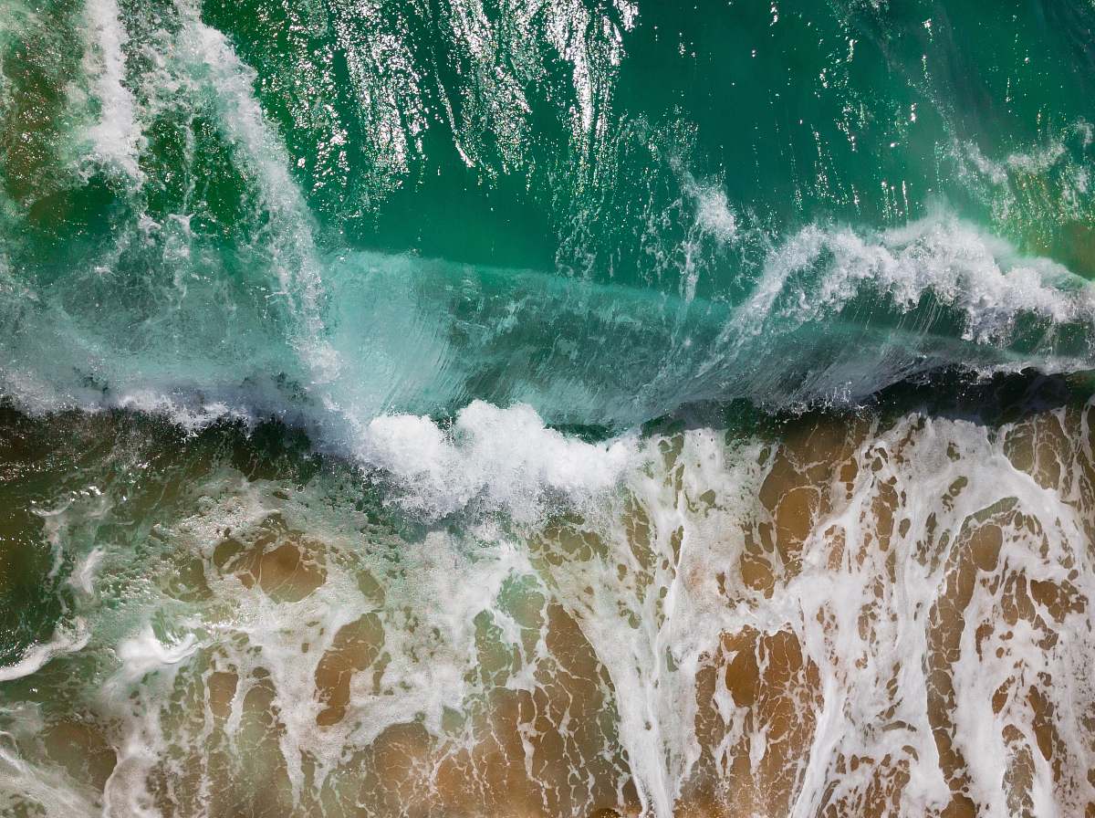 ocean aerial photography of sea waves on seashore during daytime sea