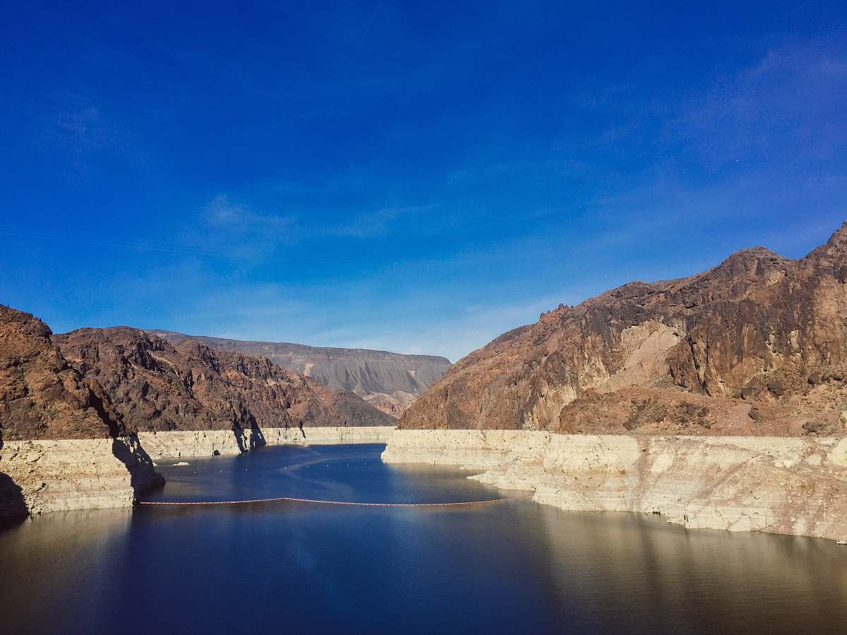 outdoors river cutting through the rocky mountains dam