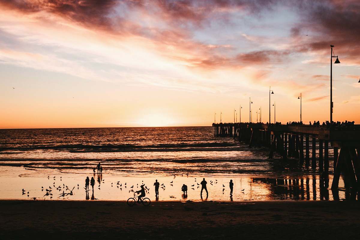 waterfront silhouette of people on seawater during golden hour dock