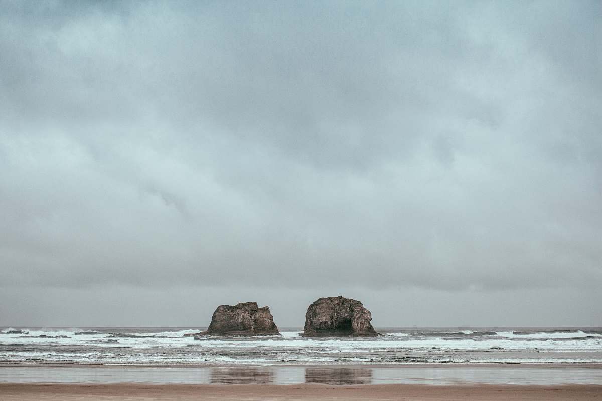 sea two gray rocks on body of water grey