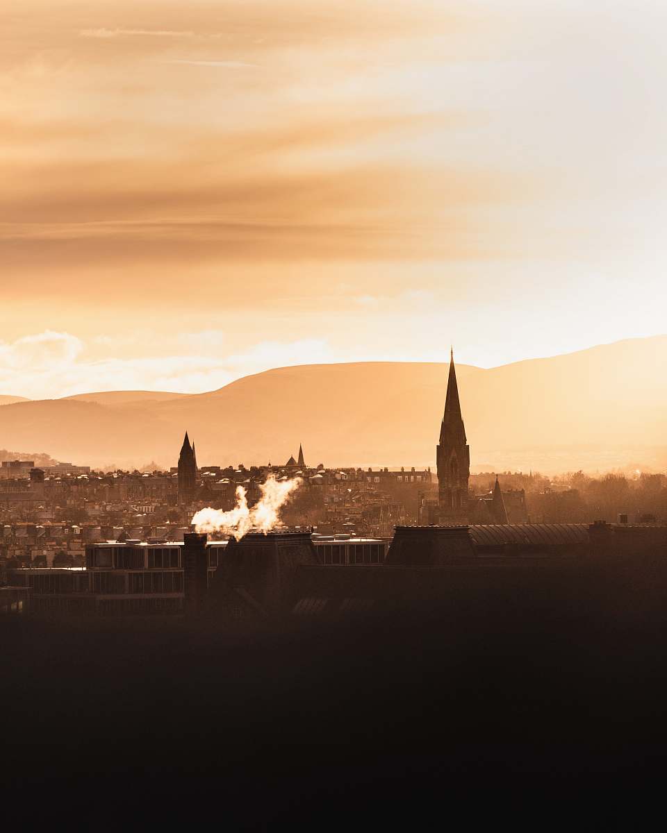 building aerial view on town with tower building during golden hour spire