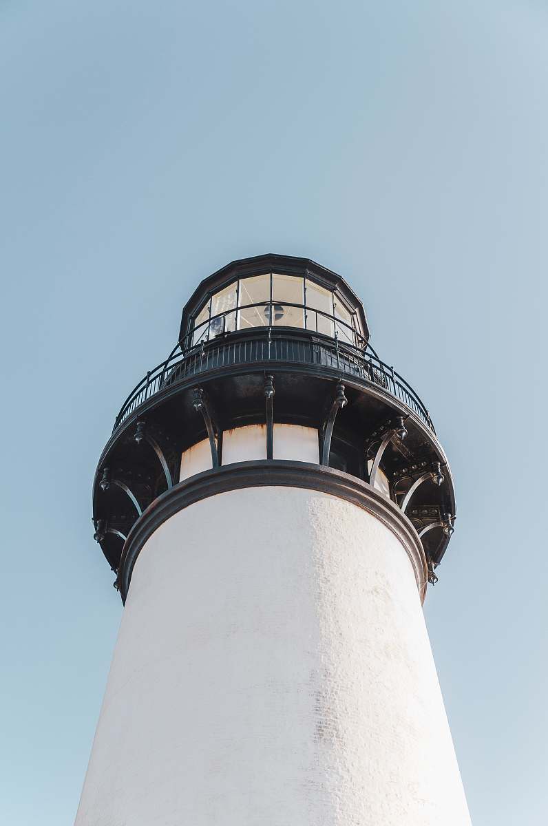 building architectural photography of white and black lighthouse tower