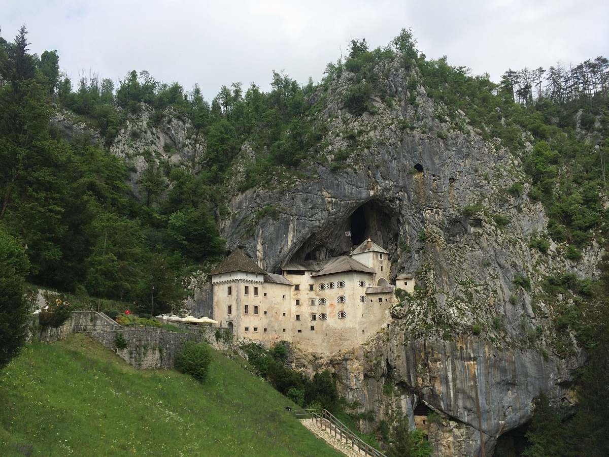 building beige castle by the rock mountain cave monastery