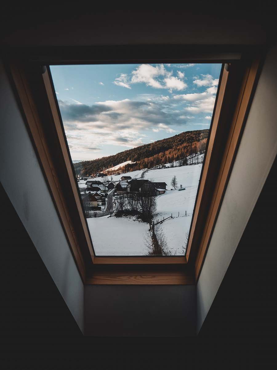 building black car on snow covered ground window