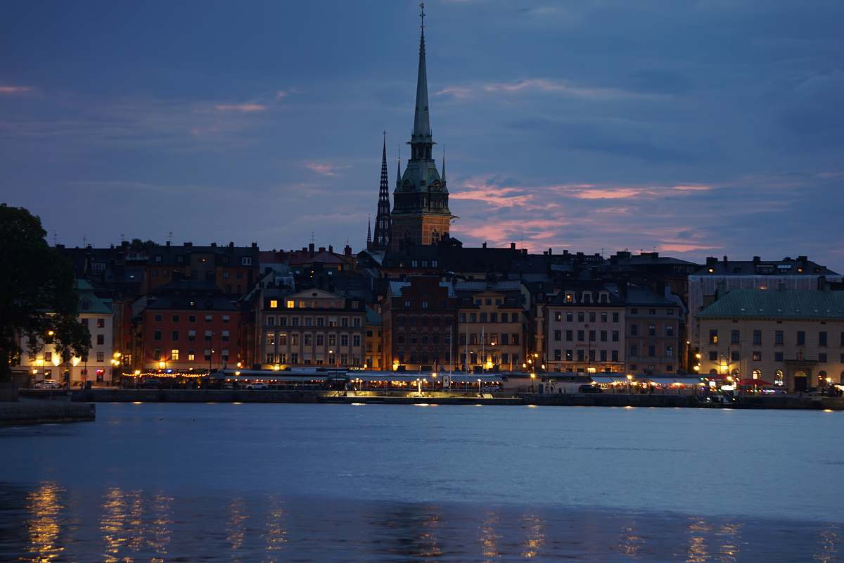 building body of water across city buildings spire