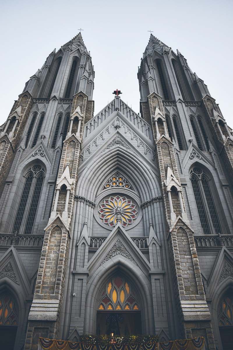 building bottom view of cathedral under white sky spire