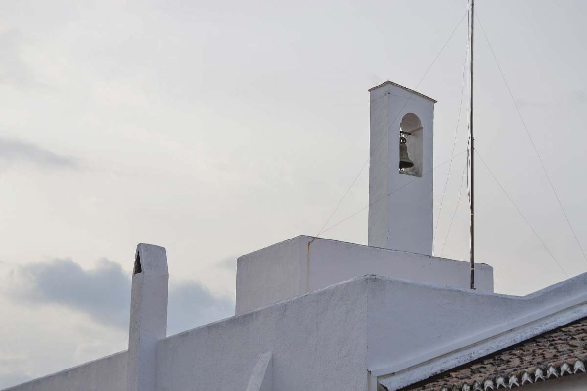 building brass bell across gray cloud grey