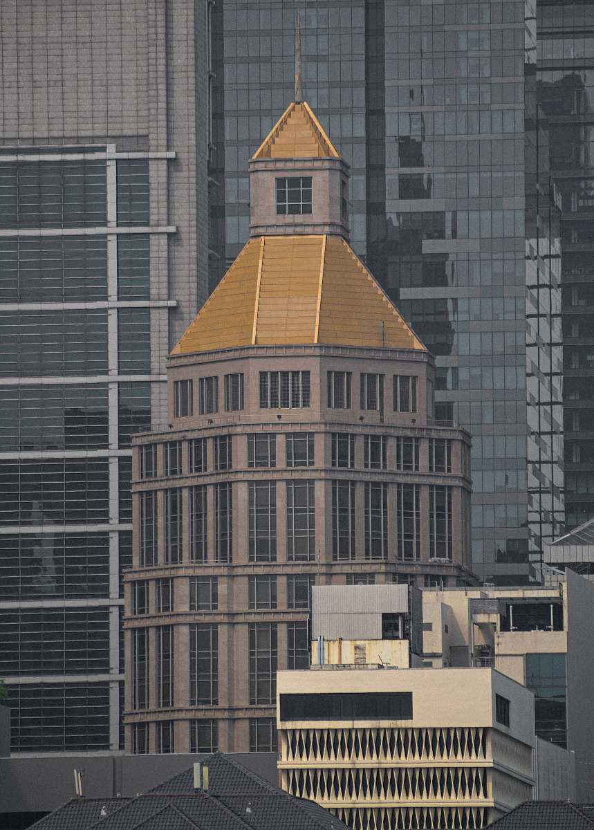 building brown and gold cement tower spire