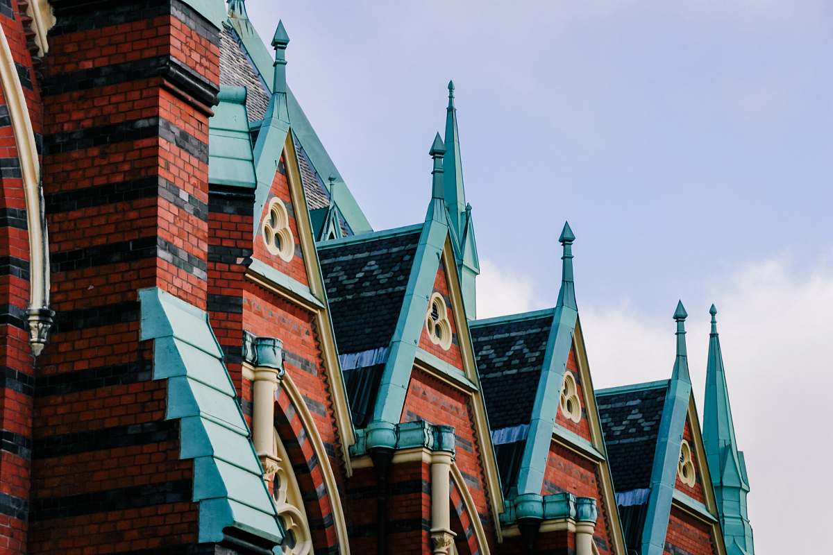 spire brown and green concrete buildings steeple