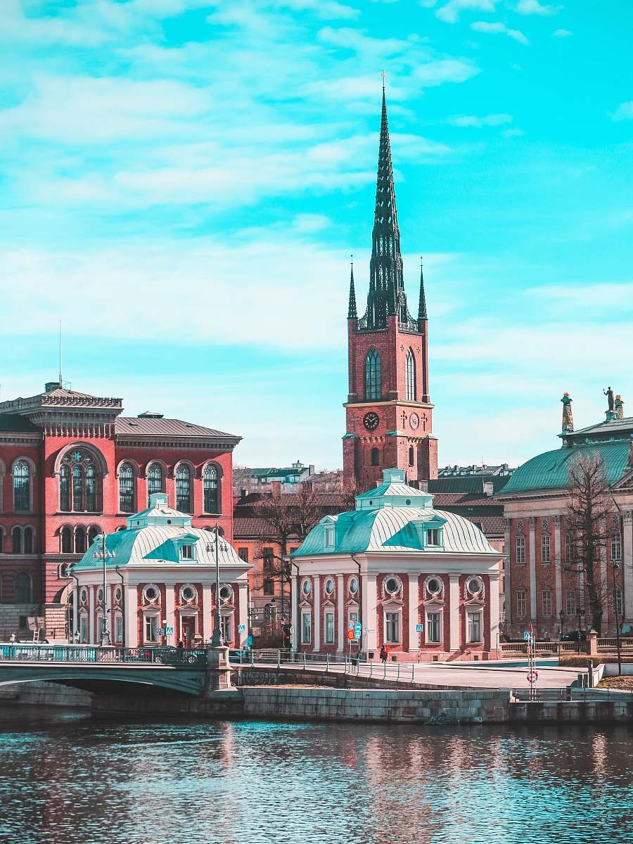 spire brown and white buildings building