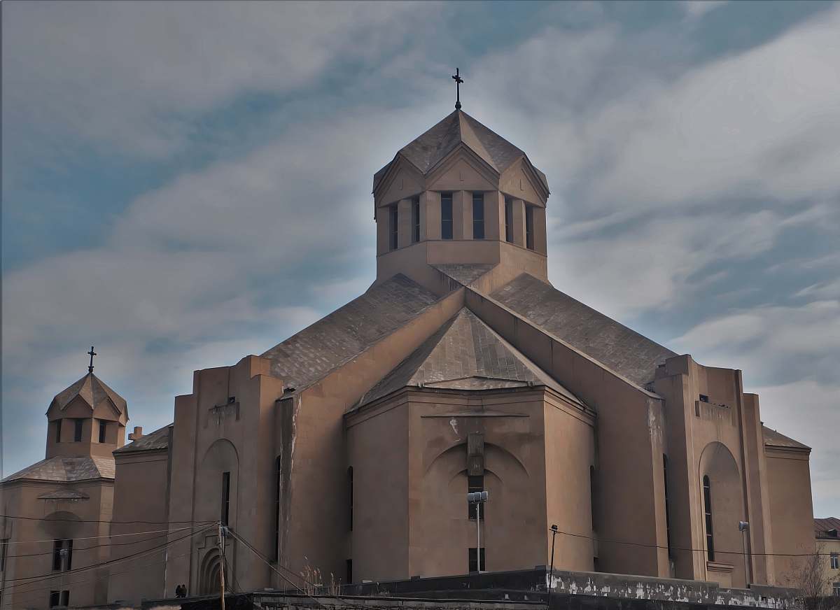 This captivating image showcases a majestic brown church standing proudly amidst the bustling cityscape, framed by a dome of dramatic, cloudy skies. The architectural beauty of the building contrasts beautifully with the urban environment, making it an ideal choice for projects related to spirituality, travel, urban development, and architectural design. Perfect for use in brochures, websites, or articles focused on city life, religion, or historical landmarks.