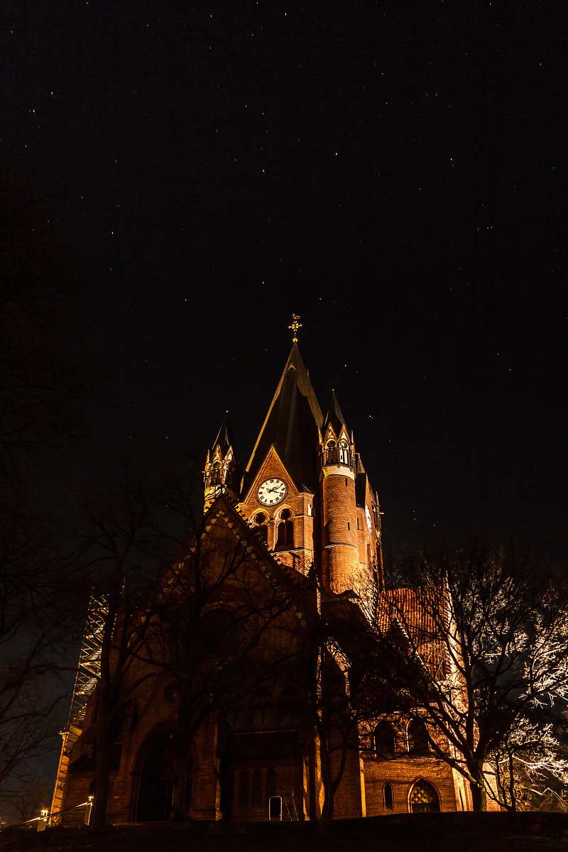 building brown cathedral during nighttime tower
