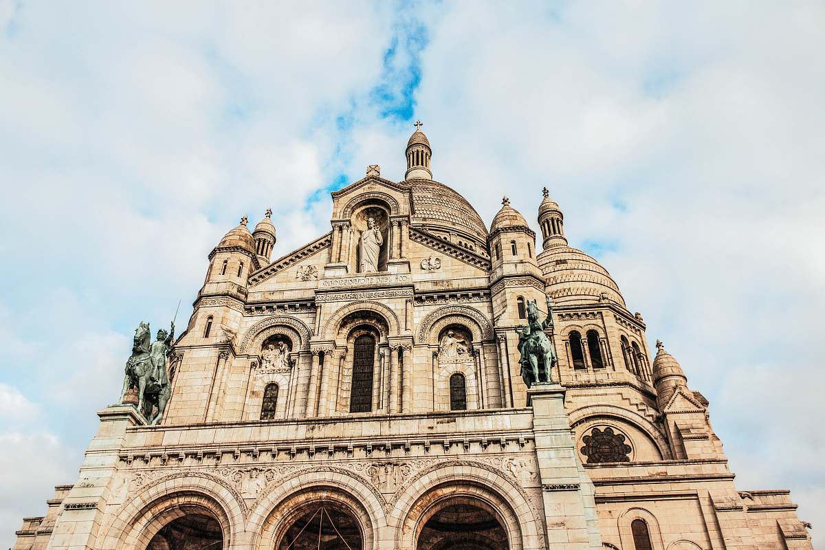 building brown cathedral under grey cloudy sky dome