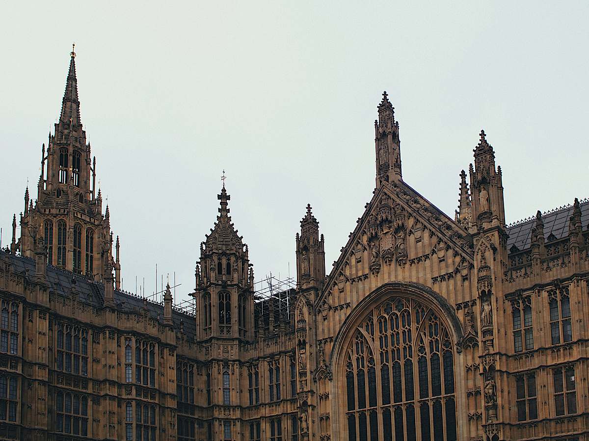 building brown church during daytime spire