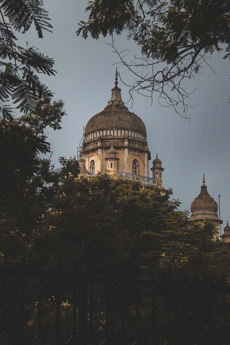 building brown concrete building beside green trees dome