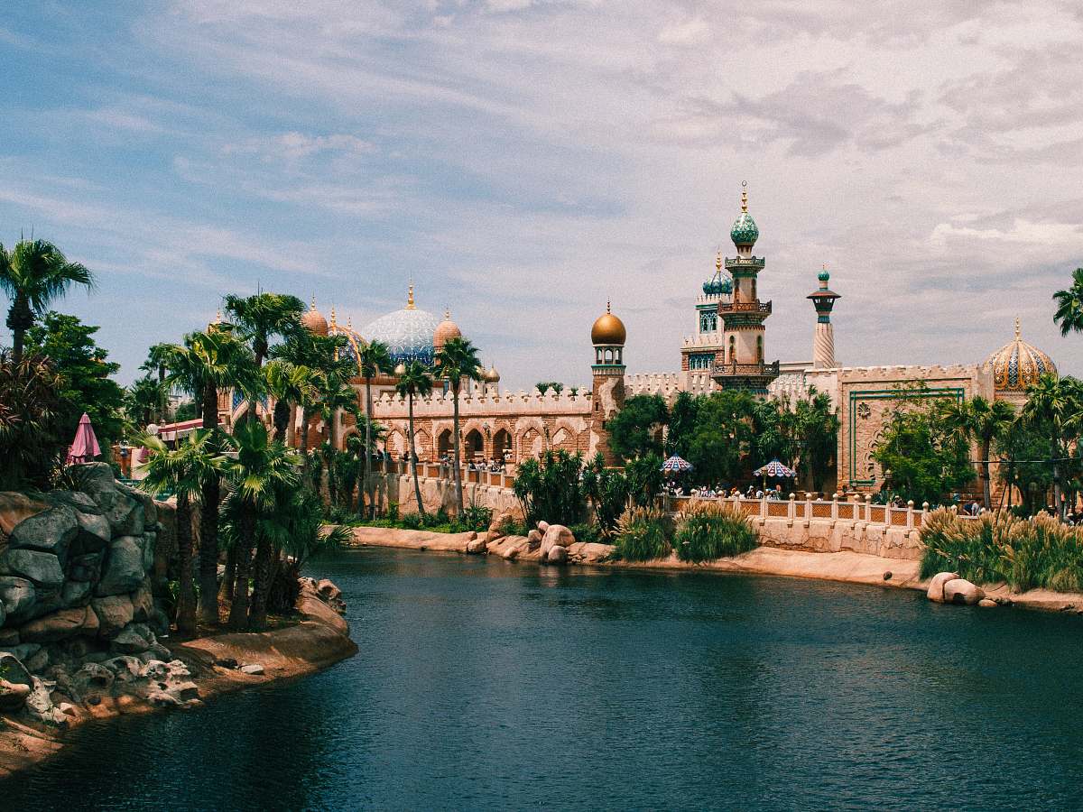 building brown concrete buildings across calm body of water dome