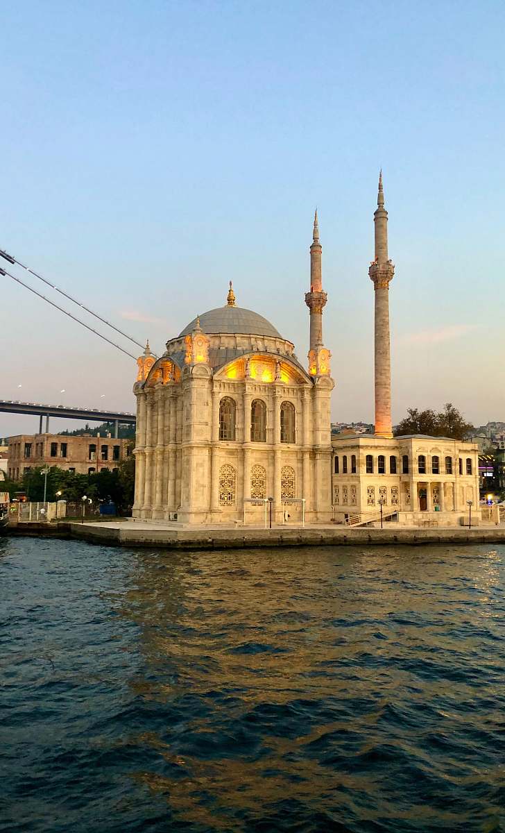 building brown concrete dome building beside body of water dome