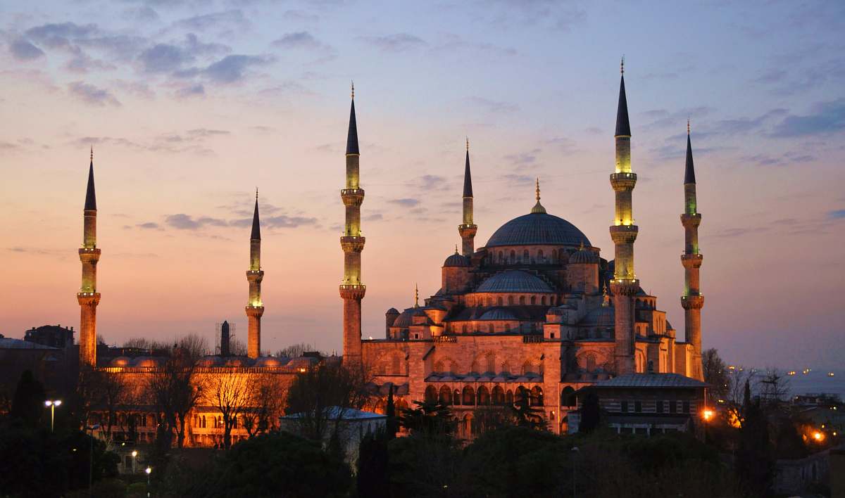 building brown dome castle with towers lighted up during sunset dome