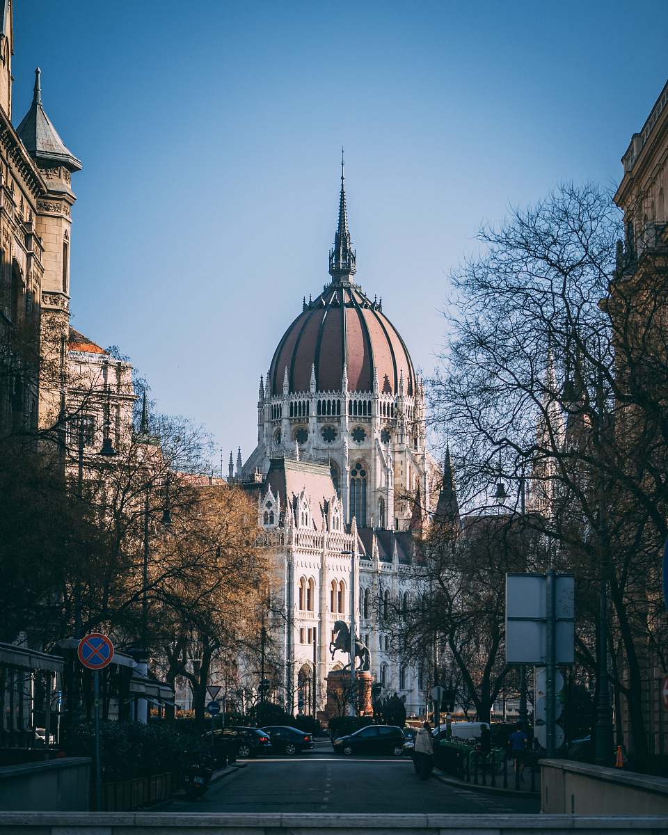 building brown domed white building down the street dome