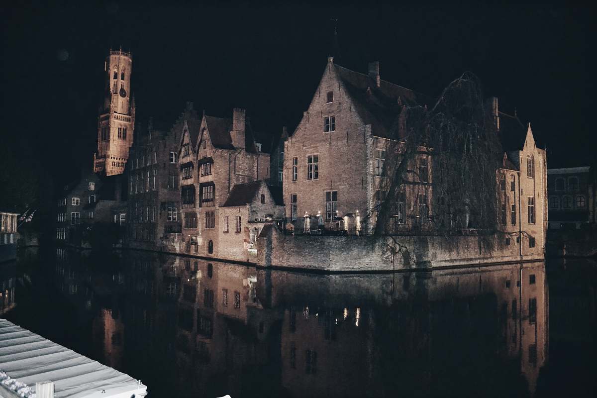 building brown house beside river castle