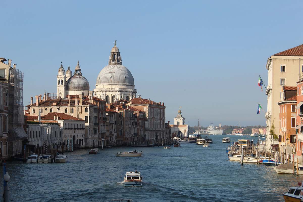 building buildings, boats, and body of water during day dome