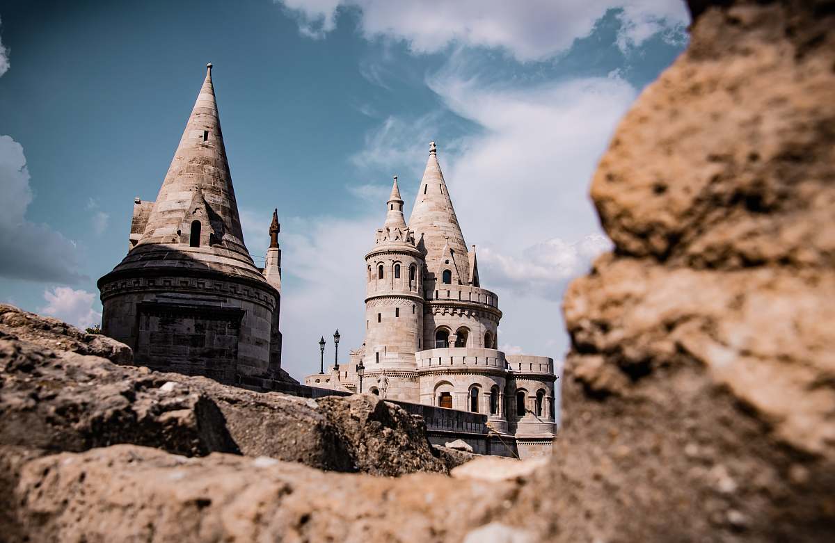 building castle near rock formations spire