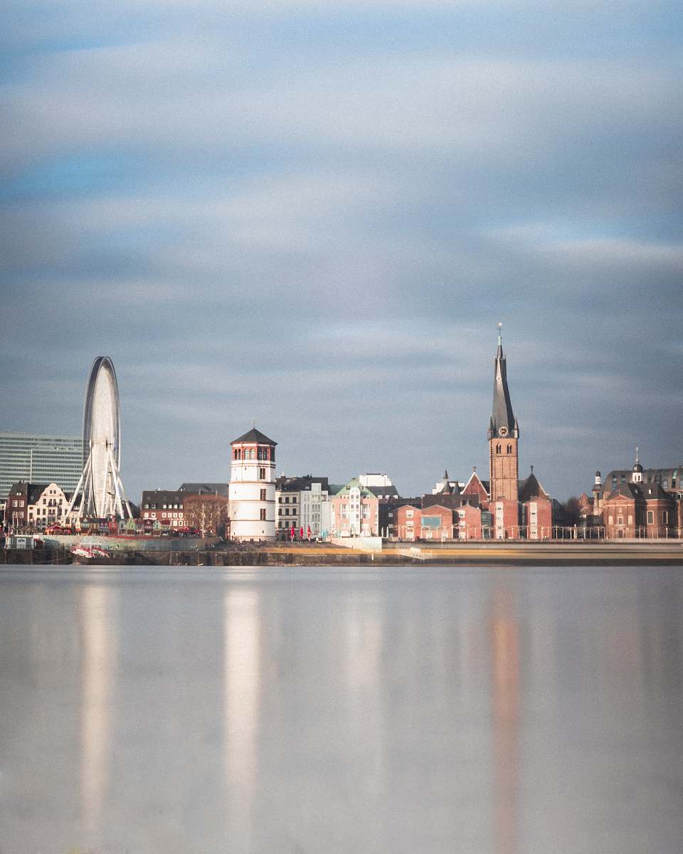 building city buildings by the ocean under white clouds spire