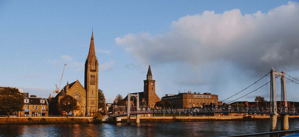 building city with high-rise buildings viewing blue sea under white and blue sky during daytime spire