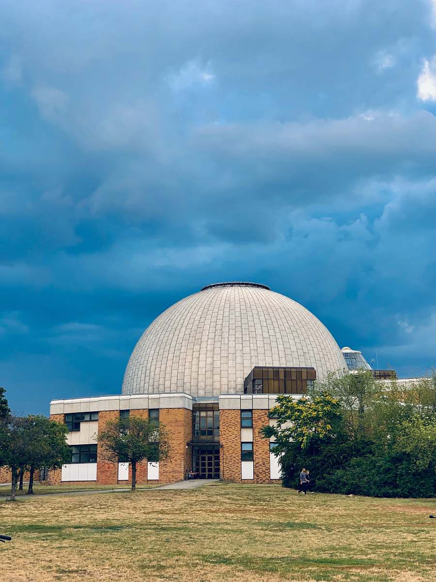 building dome building under dark clouds planetarium