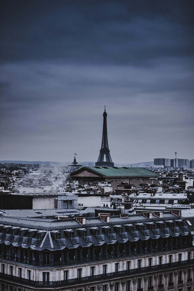 Experience the enchanting beauty of the Eiffel Tower as it majestically rises amidst the quaint spires of small buildings in the heart of Paris. This captivating scene captures the essence of the French capital, combining iconic landmarks with the charming character of local architecture. Perfect for travel blogs, romantic getaway promotions, or any content celebrating Parisian culture and heritage.