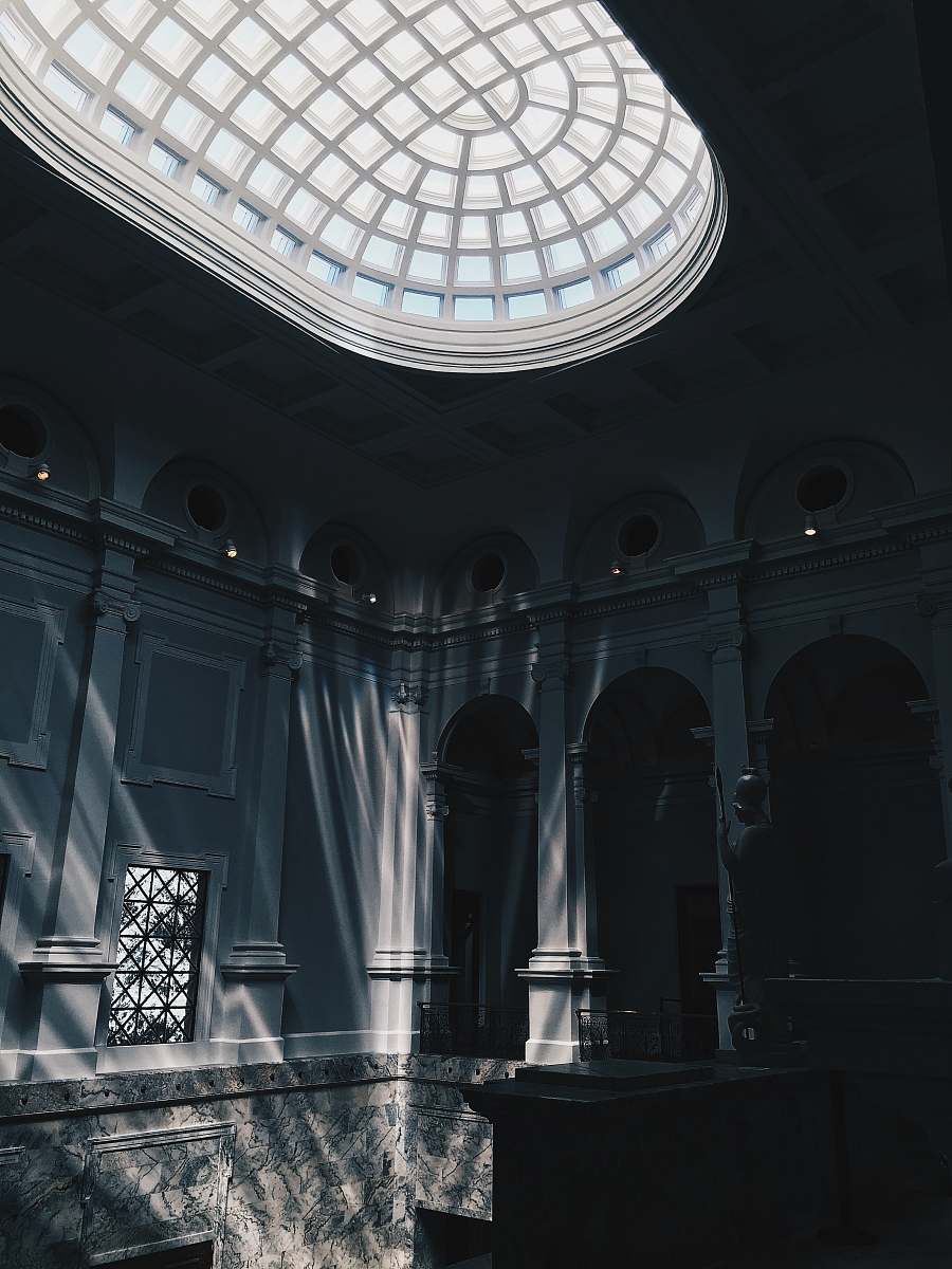 building glass panel roof near arch-shaped doorways skylight