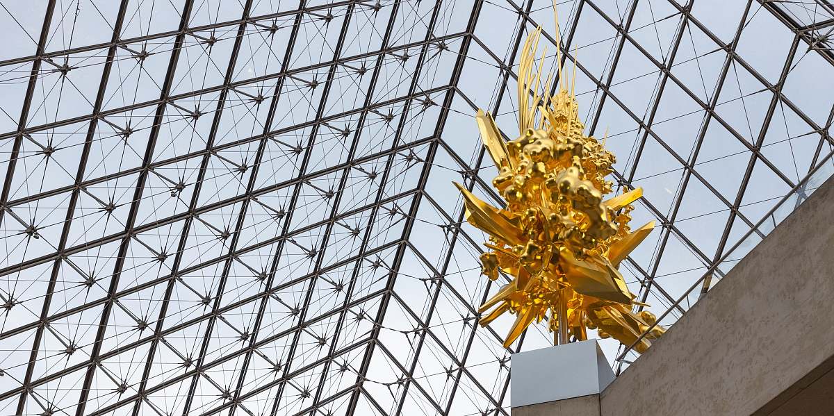 building gold-colored statue low-angle photography window