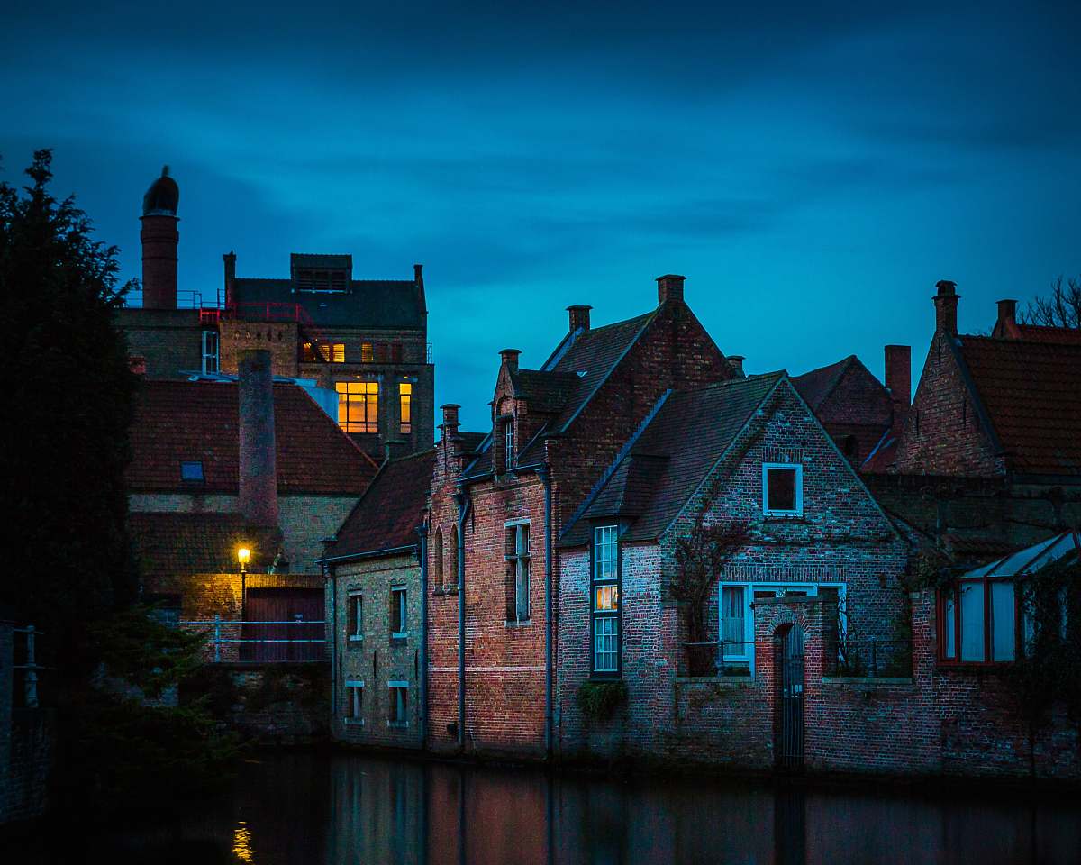 building gray and brown buildings near body of water castle