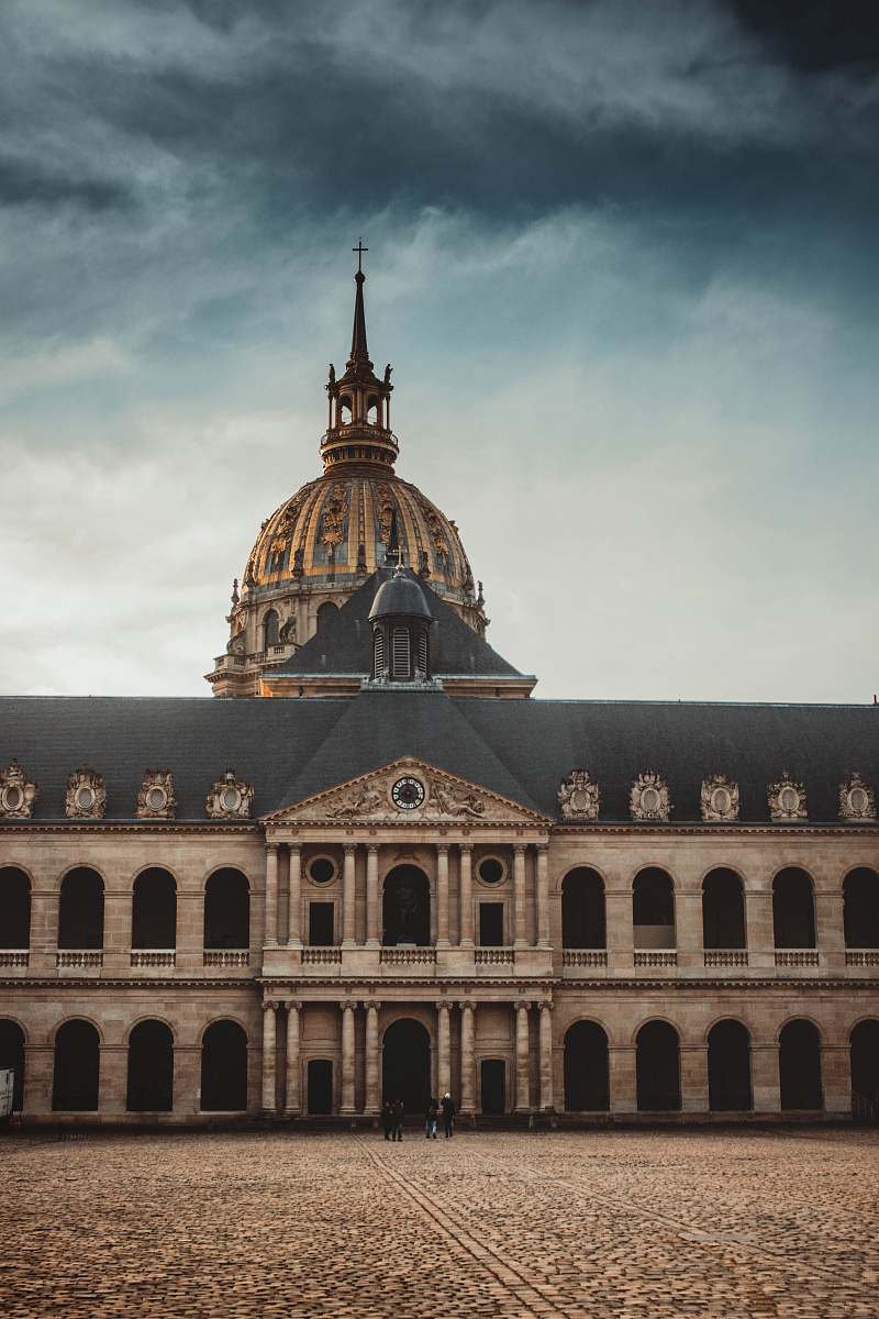 building gray and brown dome building under cloudy sky during daytime dome