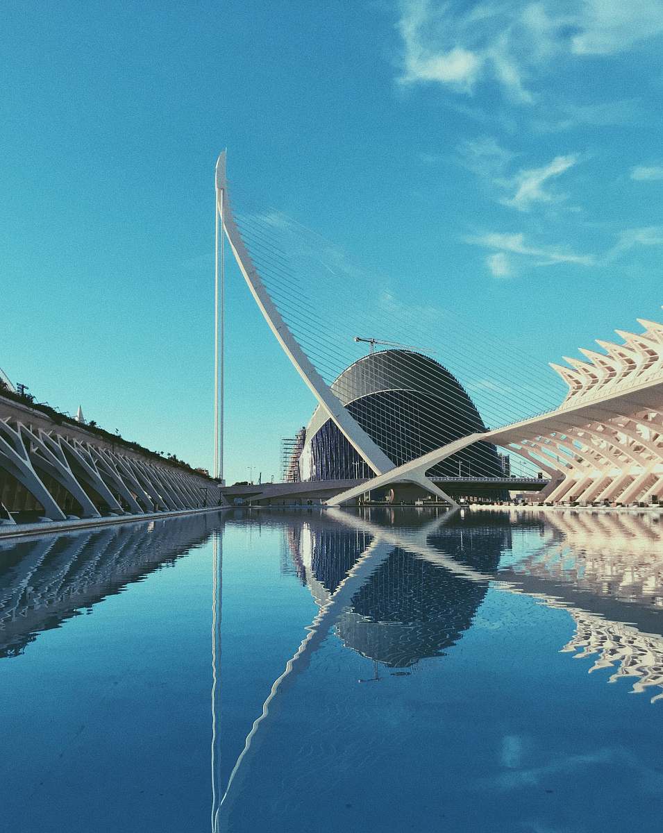 building gray building near body of water under white sky planetarium