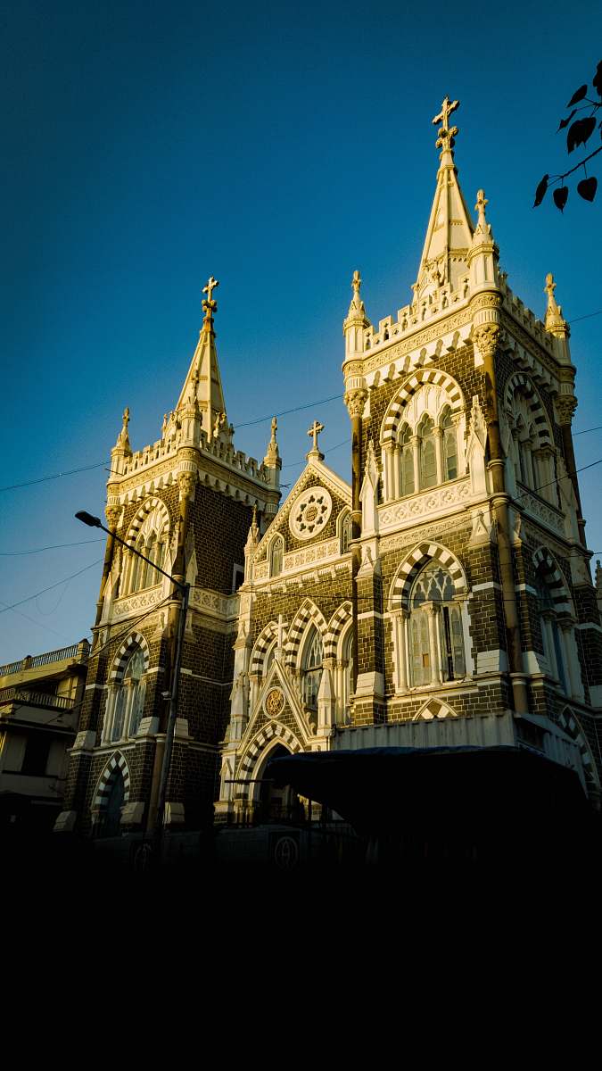 building gray church during daytime spire