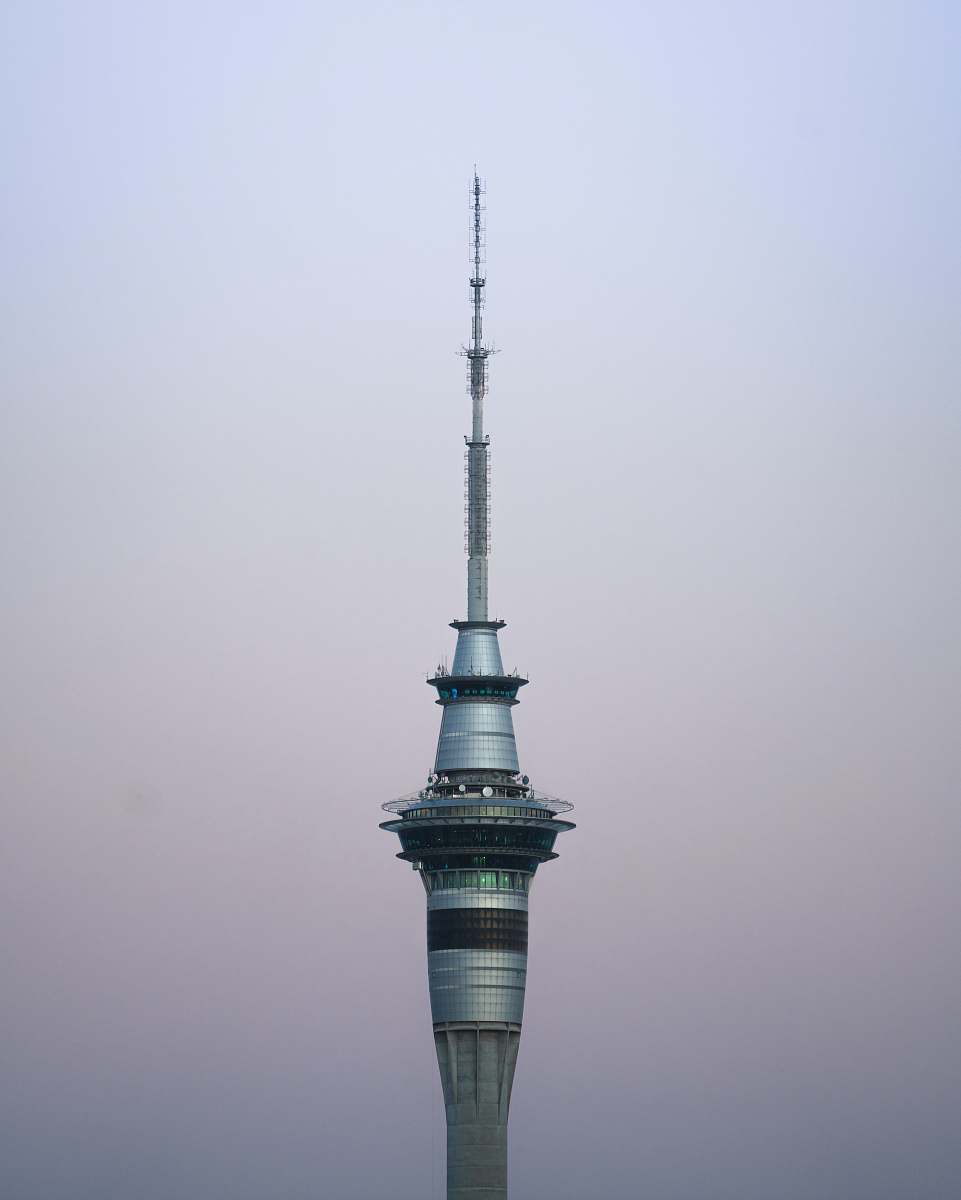 building gray concrete building under clear blue sky spire