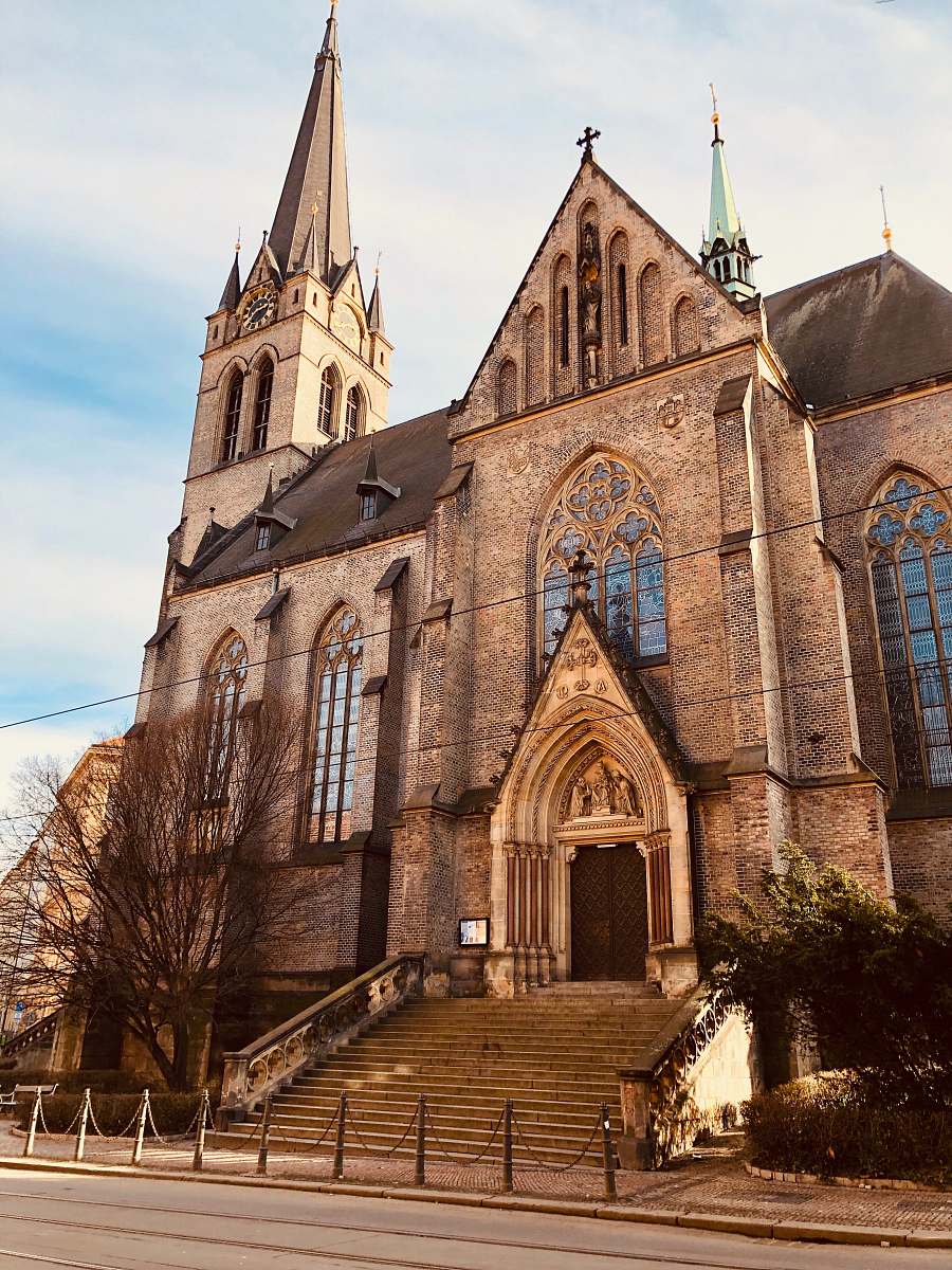 building gray concrete church during daytime spire
