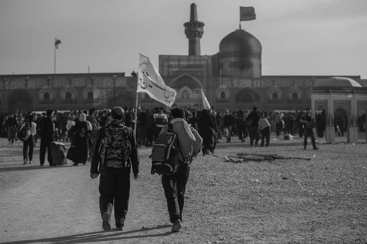 building grayscale photo of people near structure black-and-white